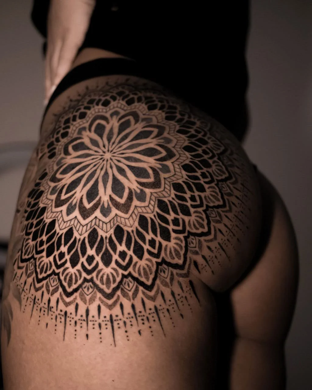 black mandalas tattoo on the cheek for girl