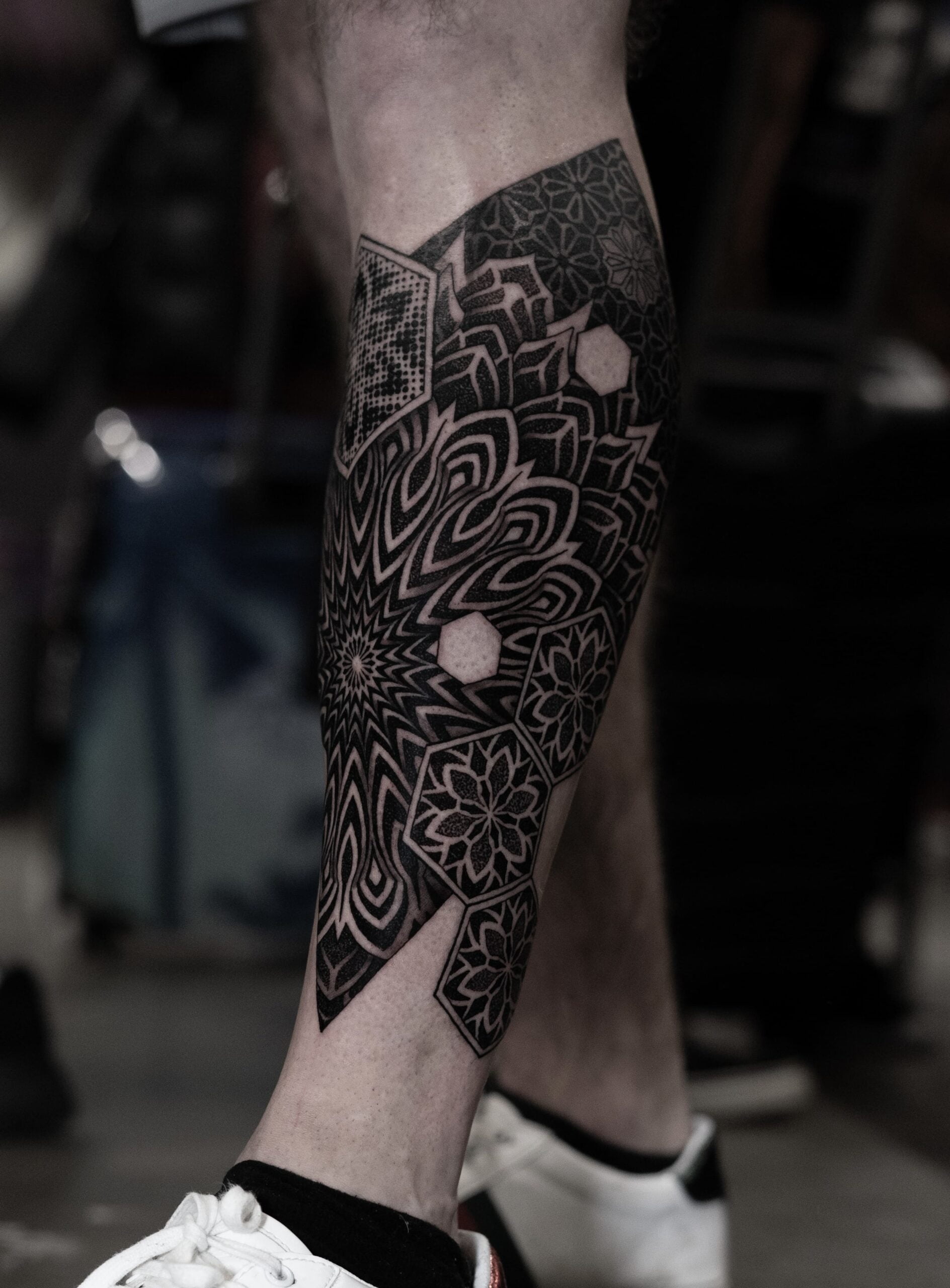 black ornamental tattoo on leg